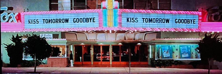 A cinema with a bright sign that says the film is called Kiss Tomorrow Goodbye.